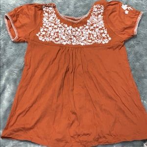 Oran’s and white embroidered blouse